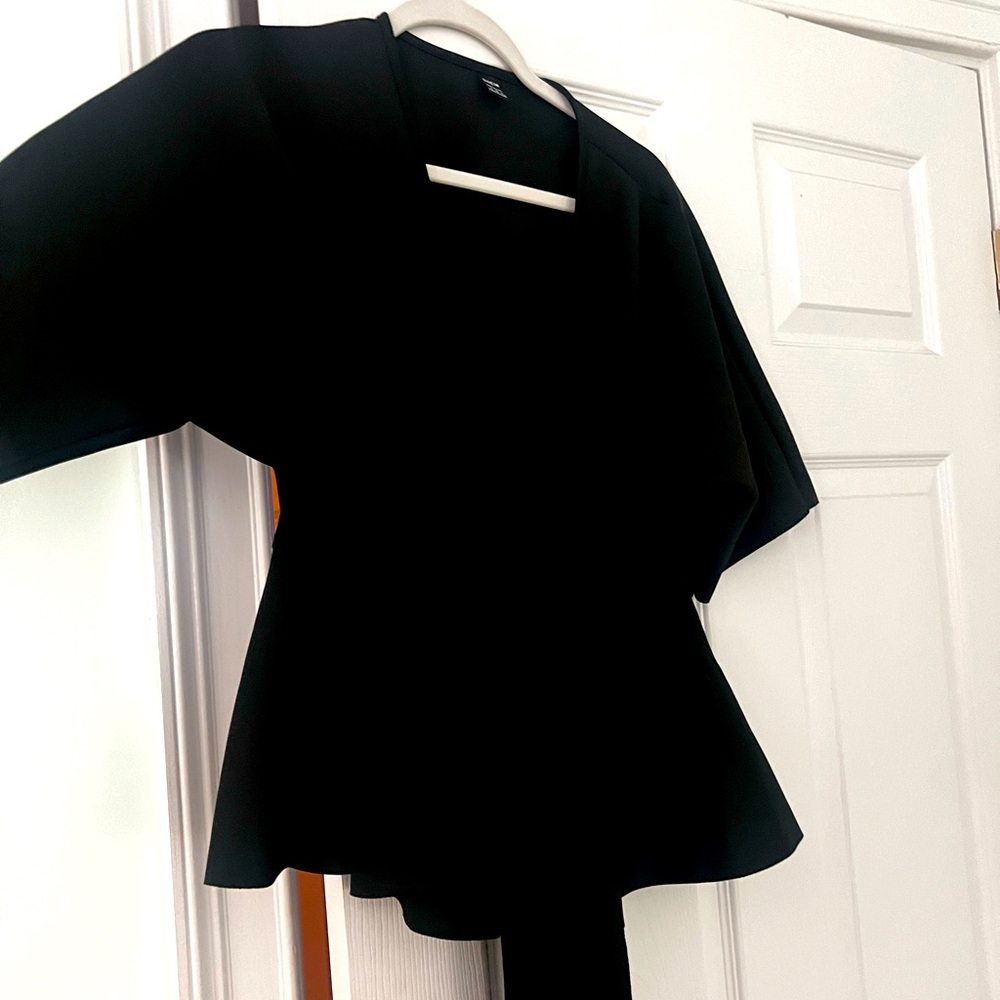 a plunge neck top with a tie.